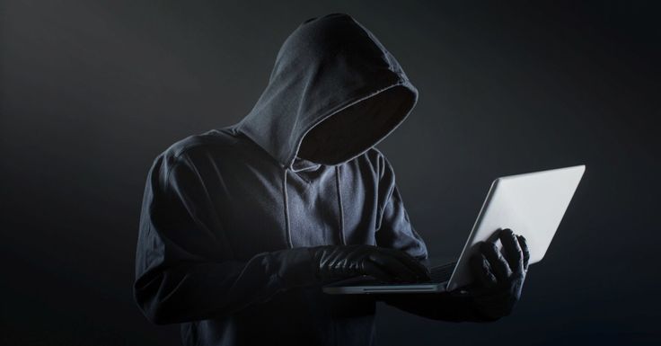 Side,view,of,male,hacker,with,gloves,and,laptop.,resolution